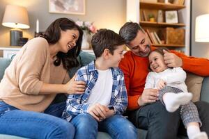 A family sitting on a couch together photo