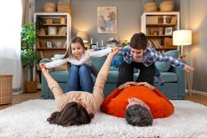 A family is playing on the floor in a living room photo