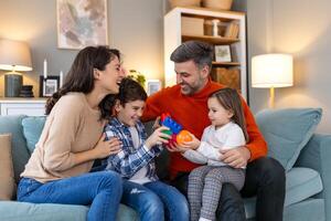 A family sitting on a couch playing with toys photo