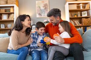 A family sitting on a couch playing with toys photo