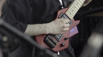 Enjoy the captivating performance of a unique electric guitar design during a dynamic show. Clip photo