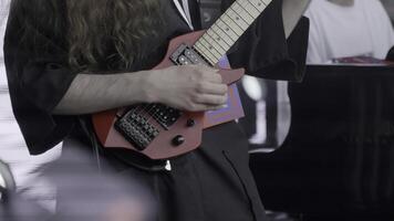 A Talented Musician Skillfully Performing Live with a Unique and Striking Red Guitar on Stage. Clip photo