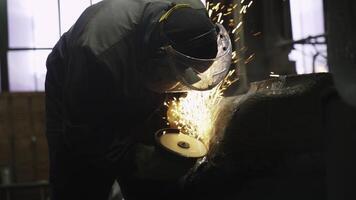 A worker welds in an industrial setting, demonstrating key skills and craftsmanship. Stock Clip photo