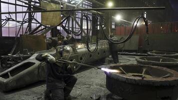 An Industrial Workshop Featuring Workers Operating in a Heavy Machinery Environment. Stock Clip photo