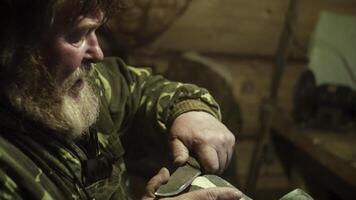 An experienced craftsman skillfully carves wood within a rustic and charming workshop setting. Stock Clip photo