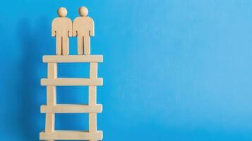 Businessman standing on ladder on blue background. Concept of career growth photo