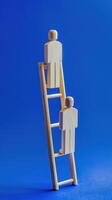 Businessman standing on ladder on blue background. Concept of career growth photo