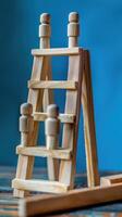 Businessman standing on ladder on blue background. Concept of career growth photo