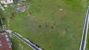 Aerial view of people playing soccer on green grass field in public park photo