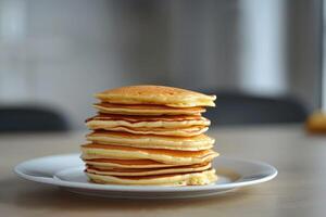 A tall stack of pancakes perfect for a family breakfast with a shallow depth of field and an empty area for additional content photo