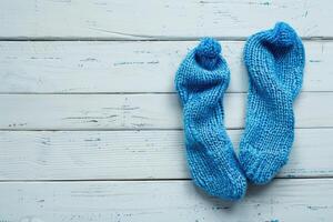 A copy space image of blue socks resting on a surface made of white wood photo