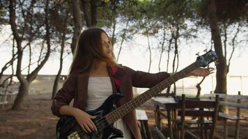 Girl Adjust Handles To Tune Bass Musical Instrument In The Park video