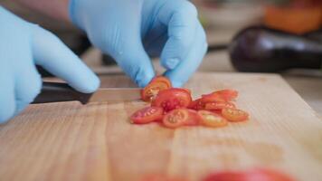 Chef Cuts Red Cherry Tomatoes On A Wooden Cutting Board video