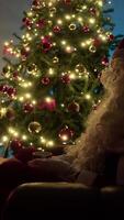 Santa Claus Rests On The Sofa And Drinks Tea Next To The Illuminated Tree video