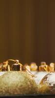 Box Of Gold Color Christmas Balls Spinning In Front Of The Illuminated Tree video