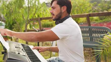 Musician Rehearses Singing And Playing Keyboard In The Park Before A Concert video