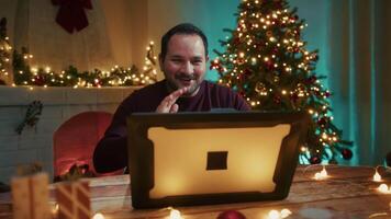 Man Makes Call With Computer In His Room Decorated For Christmas video