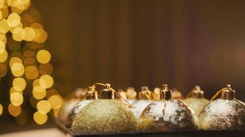 Box Of Gold Color Christmas Balls Spinning In Front Of The Illuminated Tree video