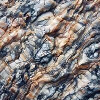 A close up of a marble. A picture of a rock face. Layered rock surface with distinct cracks and varying shades of gray photo