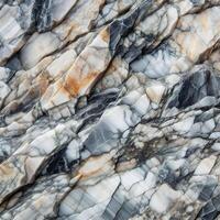A close up of a marble. A picture of a rock face. Layered rock surface with distinct cracks and varying shades of gray photo