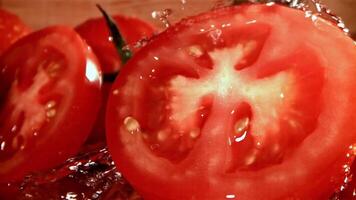 Fresh tomatoes with a splash of water. Filmed on a high-speed camera at 1000 fps. High quality FullHD footage video