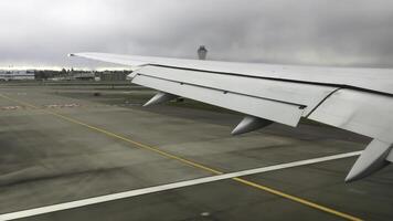 Airplane Wing During the Process of Landing on a Cloudy and Overcast Day in the Sky photo