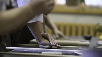 Hands at Work in a Pottery Class Engaging in the Process of Creating Beautiful Crafts Together. Stock Clip photo