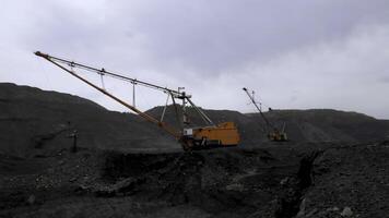 Heavy Machinery Utilized in Mining Operations Under Overcast and Cloudy Skies Conditions. Stock Clip photo