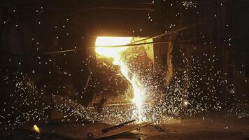 Dynamic Sparks and Molten Metal Captured in an Engaging Industrial Scene of Activity. Stock Clip photo