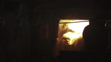 The operation of an industrial furnace using molten metal is a key process in manufacturing. Stock Clip photo