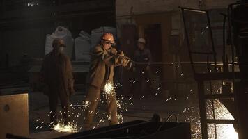 Dedicated workers are efficiently operating large machinery within an industrial setting. Stock Clip photo