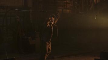 A worker laboring in a dim industrial setting, demonstrating craftsmanship and dedication. Stock Clip photo