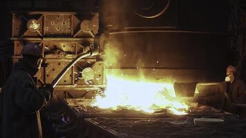 The Dynamic Molten Metal Pouring Process in a Foundry Showcases Exceptional Skill. Stock Clip photo