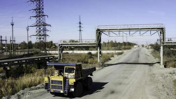 Large and Heavy Construction Machinery Positioned on a Roadway Under a Robust Metal Framework. Stock Clip photo
