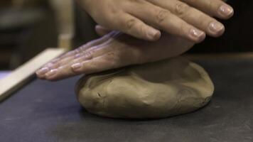 Hands are skillfully shaping clay in a pottery workshop where creativity blends with craft. Stock Clip photo