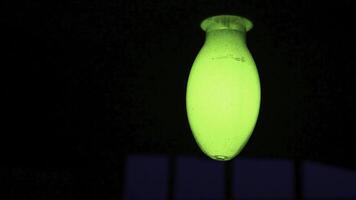 A Glowing Green Light Fixture Set Against a Dark Background, Creating an Eye Catching Contrast. Stock Clip photo