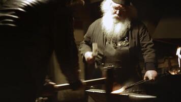 Artisan Blacksmith Skillfully Crafting Unique and Stunning Metalwork in a Historic Workshop. Stock Clip photo