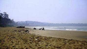 A Serene Beach Landscape featuring Gentle Waves lapping against the shore and Distant Hills beyond. Stock Clip photo