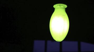 A Glowing Green Light Fixture Set Against a Dark Background, Creating an Eye Catching Contrast. Stock Clip photo