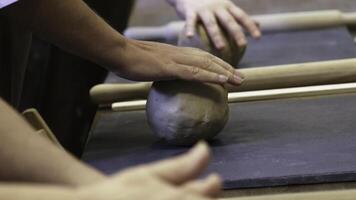 In this engaging workshop, hands skillfully shape clay during an insightful pottery craft session. Stock Clip photo