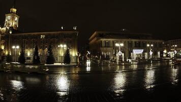 A stunning nighttime view of the busy city square filled with colorful reflections and lights. Stock Clip photo