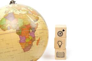 Globe and symbol icon education on wooden block cube. Learning, study, knowledge and education concept. photo