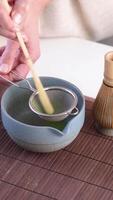 Step by step tutorial making Japanese matcha tea. Step two , sieving green matcha powder video