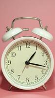 Vertical time lapse of a clock on pink background. video