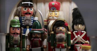 A delightful assortment of nutcracker figures is beautifully arranged in a festive setting, showcasing traditional Christmas decor. video