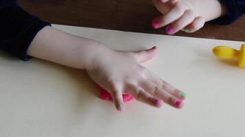 Sculpture and clay modeling for children. Girl 3-5 years old forming and shaping pink play dough by fingers and plastic modeling knife. Enhancing fine motor skills and kid creativity using play clay video