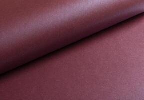 Metallic burgundy paper background with a smooth, shimmering surface and elegant folds. Featuring a photo