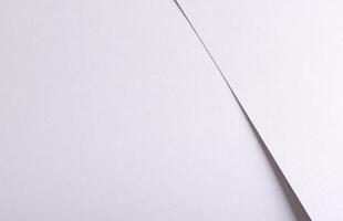 White matte paper background with a smooth texture and subtle grainy finish. Featuring fine folds photo