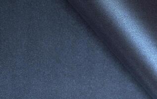 Dark blue rolled paper background with a smooth, glossy texture and luminous shimmer. Elegant and photo