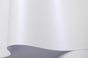 Pearle glossy paper background with a glowing iridescent texture. Pastel shine and smooth surface photo